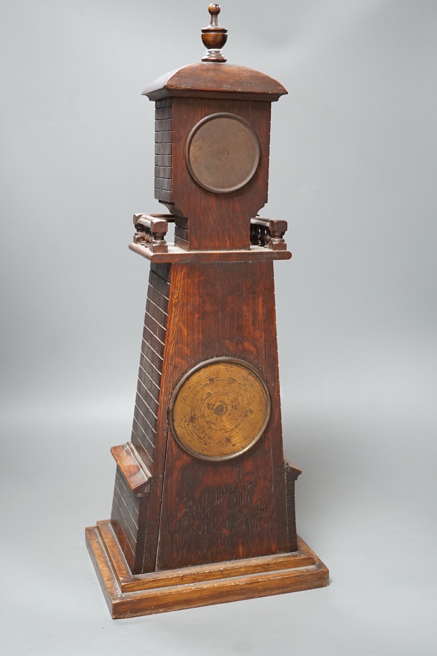 A late Victorian carved oak 'lighthouse' combined mantel timepiece and barometer, signed Frank Flower, St James' St, S.W, Height 53 cm